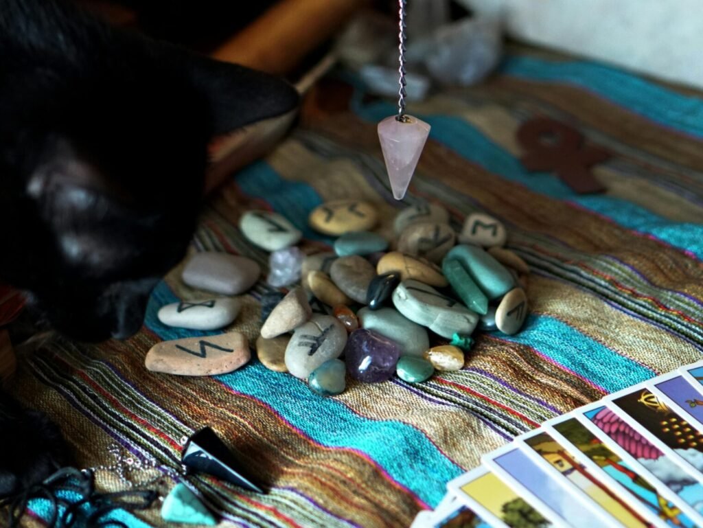 A black cat with a pendulum and tarot cards, creating an aura of mysticism and divination.
